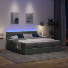 Vidaxl Otomanski posteljni okvir z vzmetnicami siv 180x200 cm blago