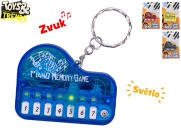 Toys&Trends 6 cm obesek za ključe s klavirjem na baterije s svetlobo in zvokom 19 pesmi - mešanica barv (rumena, črna, rdeča, modra)