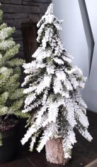 majhna, mini, umetna, s snegom prekrita božična jelka na deblu
